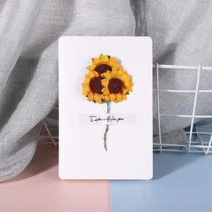 Detail of white greeting card with mini dried sunflowers and Especially for you text