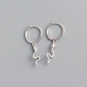 Detail view of silver S925 snake earrings with subtle stone accents on a grey background