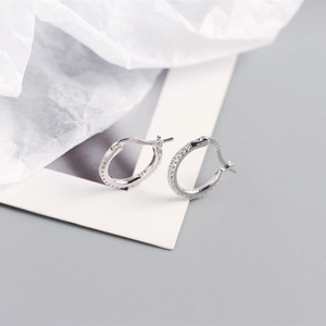 Macro shot of S925 sterling silver hoop earrings with clear cubic zirconia pavé stones