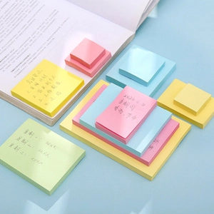Close-up of assorted mini colorful square sticky notes in yellow pink and blue for students