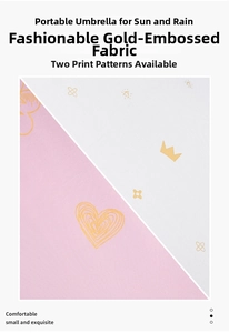 Close-up of waterproof fabric with gold heart and crown prints for folding umbrella