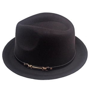 Detail of classic black wool jazz hat with a slim leather band and golden buckle