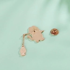 Back view of gold-plated cat and fish enamel pin with chain and butterfly clasp detail