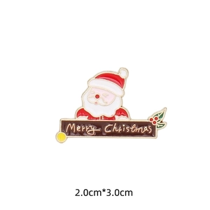 Detail of Christmas Santa enamel pin with Merry Christmas banner and gold metal edges