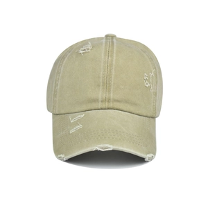 Close-up of distressed khaki ponytail baseball cap showing torn hole details and texture