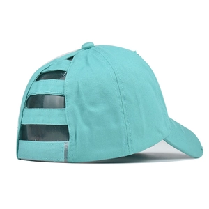 Detail of mint green ponytail baseball cap showing the criss-cross elastic back design