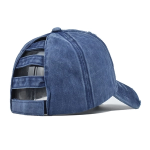 Detail of navy blue washed denim ponytail baseball cap with distressed frayed edges