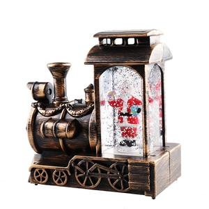 Retro bronze Christmas train decoration with Santa Claus figure and shimmering glitter snow