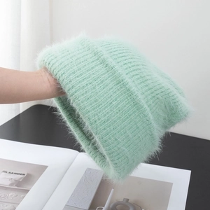 Detail of mint green fuzzy knit hat showing long plush texture and mohair material