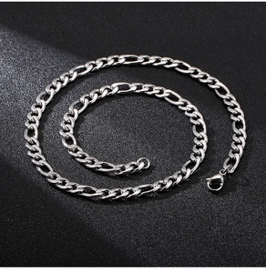 Macro view of silver Figaro chain showing 3+1 link details and lobster clasp closure