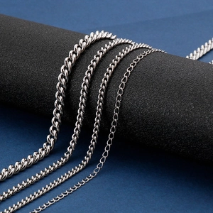 Polished stainless steel Cuban and O-link chain necklaces for men on display