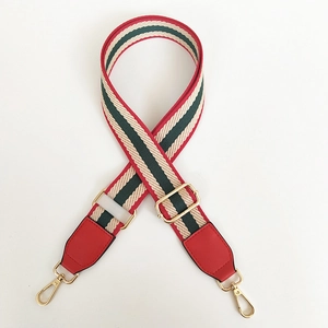 Adjustable woven handbag strap with red and green stripes and gold metal hardware