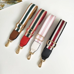 Detail of four colorful striped fabric and leather replacement bag straps with gold hardware