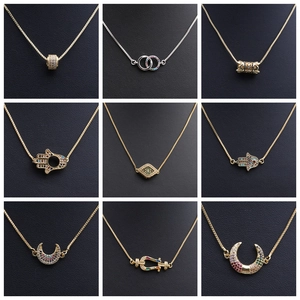 Close-up of gold and silver necklaces with moon and star pendants set with colorful zircon