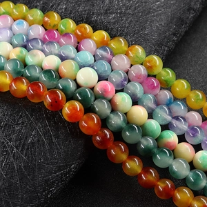 Polished 10mm colorful agate round beads for DIY jewelry making on dark textured background