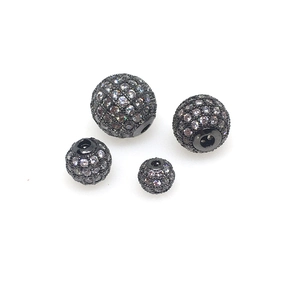 Macro shot of micro-pave white zircon spherical spacer beads in gunmetal black finish