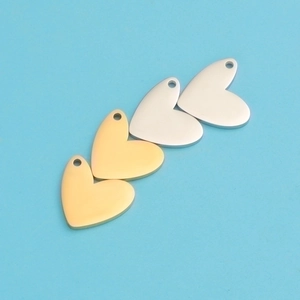 Macro shot of gold and silver heart-shaped metal pendants for DIY jewelry making