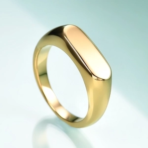 Macro shot of minimalist gold polished rectangular bar signet ring with mirror finish