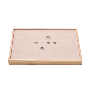 Wooden jewelry tray with pink velvet lining and slots for ring and earring storage
