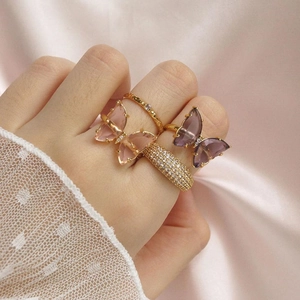 Elegant gold-plated set featuring crystal butterfly rings and shimmering pavé bands