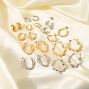 French vintage 18K gold plated stainless steel earrings set on beige silk fabric