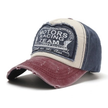 Close-up of distressed vintage baseball cap with Motors Racing Team patch embroidery
