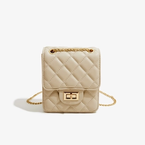 Detail of beige quilted PU leather crossbody bag featuring gold chain and square metal clasp