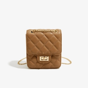 Detail of a brown quilted leather crossbody bag featuring a gold chain and square lock