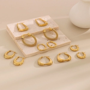 Collection of gold geometric earrings including woven textures and teardrop designs