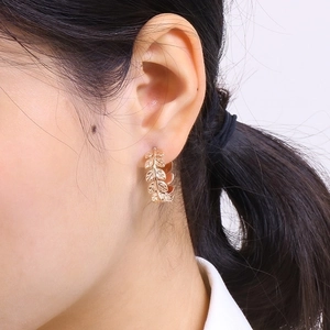Golden leaf C-shaped titanium steel earrings on female model with minimalist design