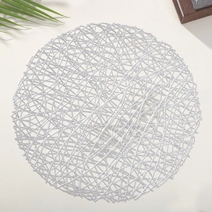 Silver round PVC hollow woven placemat for dining table setting on white background