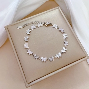 Detailed shot of silver butterfly link bracelet in stainless steel with lobster clasp