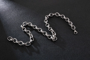 Macro shot of silver stainless steel O-link chain with a secure lobster clasp