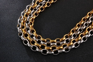 Macro detail of high-polish gold and silver stainless steel layered cable chain links
