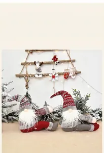 Detailed view of Christmas gnome plush dolls and wood ornaments in cozy festive setting