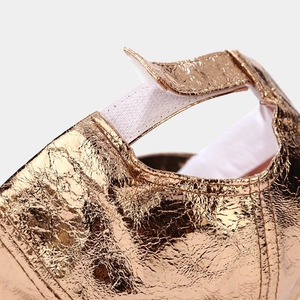 Macro detail of gold holographic baseball cap with adjustable hook and loop strap
