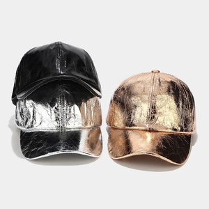 Close-up of metallic PU leather baseball caps in black, silver, and rose gold with texture