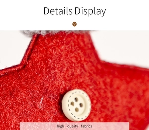 Detail of red Christmas star ornament featuring a white button and plush trim texture