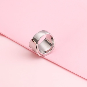 Minimalist wide band 304 stainless steel ring with polished silver finish on pink background