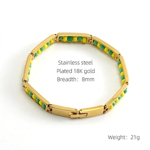 Detail view of 8mm gold plated stainless steel bracelet with green and yellow beads