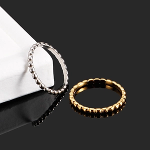 Minimalist beaded stainless steel stackable rings in polished gold and silver finishes