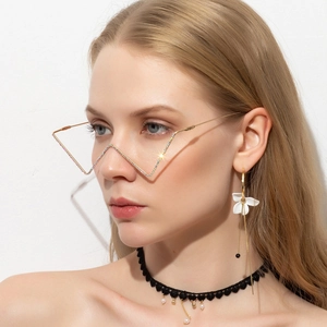 Detail of trendy gold zigzag metal spectacle frame with colorful rhinestones on female model