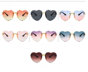 Detail of rimless heart-shaped sunglasses with scalloped edges in 7 colorful gradient lens options