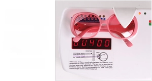 Detail shot of pink heart sunglasses on a UV400 testing device showing full protection