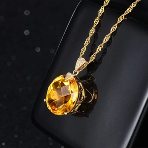 Elegant yellow gemstone pendant necklace with oval cut crystal and gold plated finish