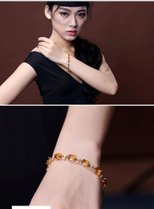 Macro shot of luxury yellow gemstone bracelet with elegant gold bow knot and diamond details