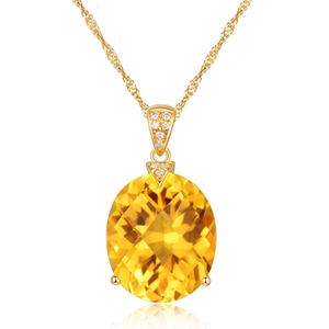 Macro detail of gold water wave chain with oval yellow gemstone pendant and diamond accents