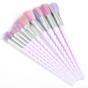 Set of 10 purple unicorn makeup brushes with rainbow gradient bristles on white background