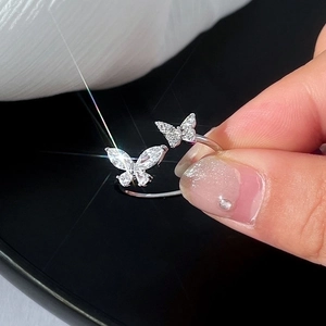 Macro shot of silver butterfly open ring with sparkling cubic zirconia in high light