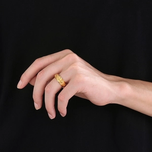 Detailed relief of sun and moon patterns on a spinning gold titanium ring for men